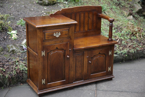 A SOLID OAK HALL SEAT PHONE TABLE MONKS BENCH SETTLE CUPBOARD.