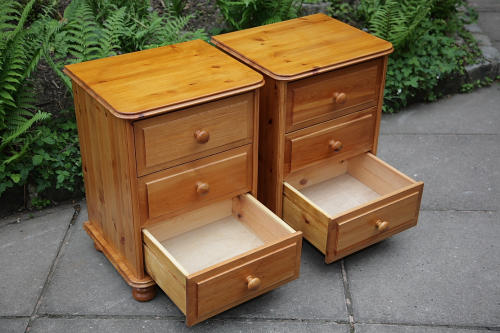 a pair of pine bedside tables / cabinets / chest of drawers