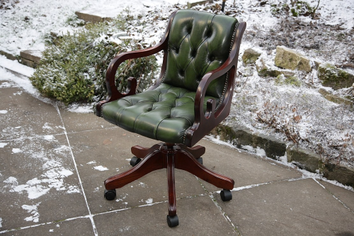 AN ANTIQUE GREEN LEATHER CHESTERFIELD DESK OFFICE TABLE SWIVEL RECLINING ARMCHAIR.