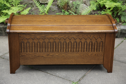 A CARVED OAK BLANKET CHEST MULE RUG CHEST LOG TOY BOX COFFER.