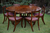 A BEVAN FUNNELL REPRODUX MAHOGANY ROUND DINING SET TABLE AND SIX DINING CHAIRS.