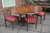 AN ERCOL SOLID ELM FRUITWOOD DINING SET CHESTER PEDESTAL EXTENDING TABLE & FOUR DINING CHAIRS.