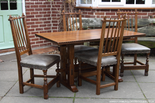 A RUPERT GRIFFITHS MONASTIC OAK DINING TABLE AND FOUR LEATHER CHAIRS
