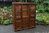 A WOOD BROTHERS OLD CHARM LIGHT OAK TALL RECESSED SIDEBOARD DISPLAY CABINET