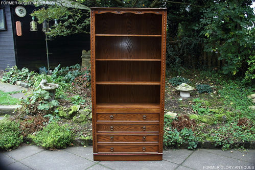 A JAYCEE AUTUMN GOLD CARVED OAK OPEN BOOKCASE SHELVES WITH DRAWERS