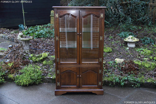 A WOOD BROTHERS OLD CHARM LIGHT OAK DISPLAY CABINET WITH CUPBOARD