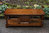 A WOOD BROTHERS OLD CHARM CARVED LIGHT OAK COFFEE TABLE WITH CUPBOARD