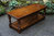 A WOOD BROTHERS OLD CHARM CARVED LIGHT OAK COFFEE TABLE WITH CUPBOARD