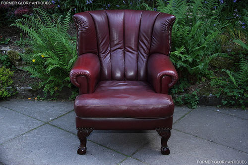 A TETRAD BLAKE BURGUNDY LEATHER CHESTERFIELD WING BACK ARMCHAIR
