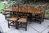 A NIGEL GRIFFITHS SOLID CARVED OAK DINING SET TABLE & SIX STICK BACK CHAIRS