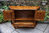 A JAYCEE AUTUMN GOLD CARVED OAK CANTED CABINET / SIDEBOARD