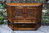 A JAYCEE AUTUMN GOLD CARVED OAK CANTED CABINET / SIDEBOARD