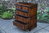 A TITCHMARSH AND GOODWIN CARVED STRESSED OAK CHEST OF DRAWERS