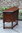 A WOOD BROTHERS OLD CHARM TUDOR BROWN CARVED OAK CANTED CABINET / HALL TABLE