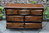 A WOOD BROTHERS OLD CHARM LIGHT OAK LONG CHEST OF DRAWERS