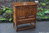 AN ERCOL GOLDEN DAWN ELM CREDENCE CUPBOARD / HALL CABINET