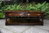 A TITCHMARSH AND GOODWIN STYLE STRESSED OAK TWO DRAWER COFFEE TABLE
