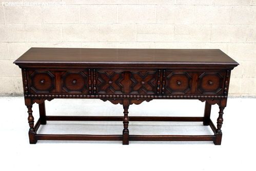 A JACOBEAN STYLE THREE DRAWER CARVED OAK DRESSER BASE / SIDEBOARD / HALL TABLE