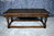 A NIGEL GRIFFITHS MONASTIC CARVED SOLID OAK COFFEE / OCCASIONAL TABLE